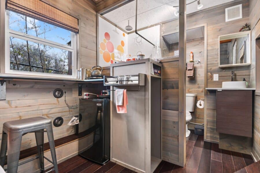 Kitchenette and open bathroom area in the Modern tiny house at Tiny Digs