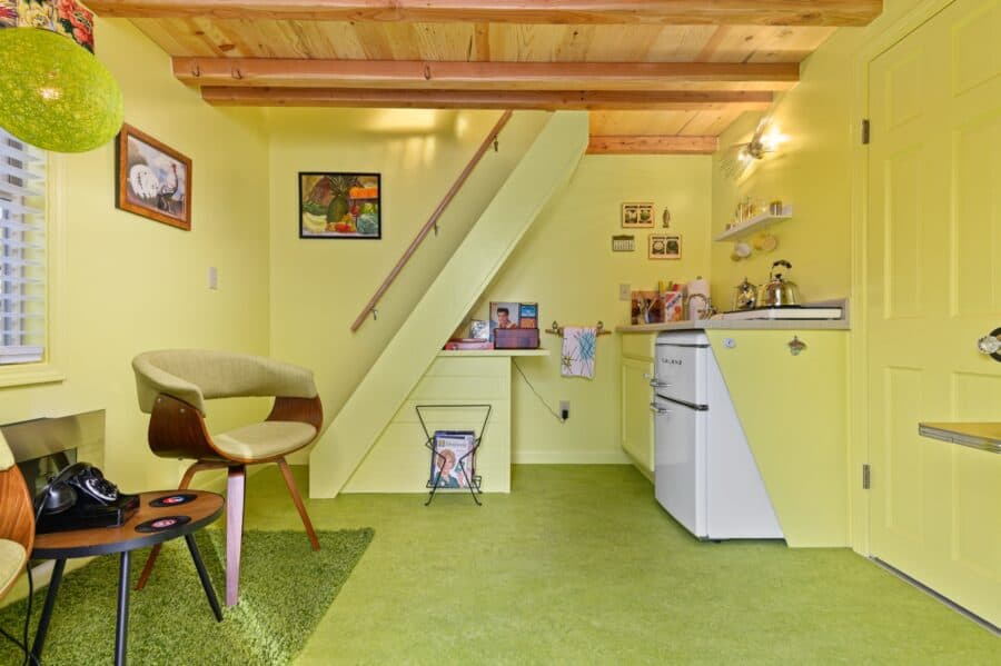 Kitchenette and stairs to the loft inside the Rock n Roll tiny house