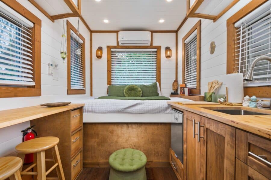 View down the Zen tiny house to the queen bed under the picture window