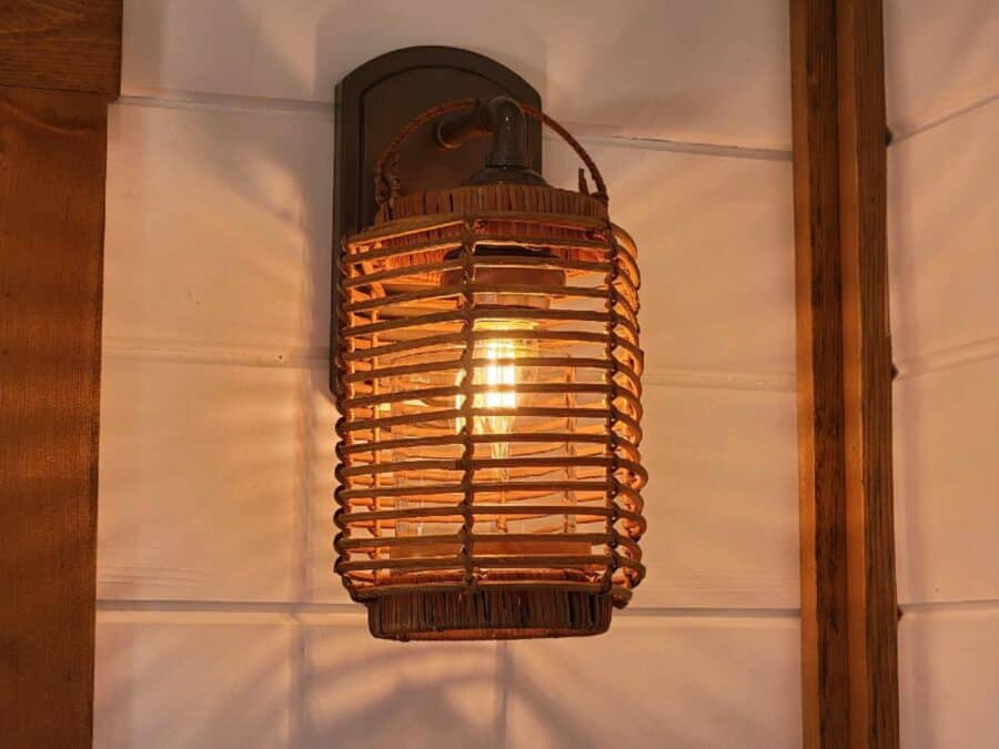 Woven rattan wall lantern inside the Zen tiny house at Tiny Digs