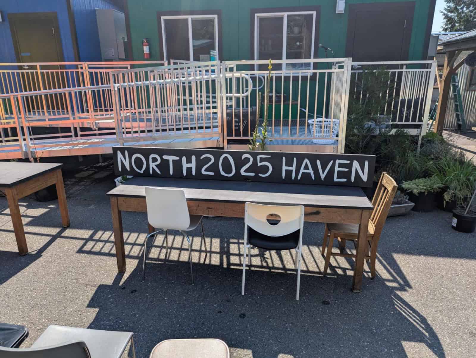 Shared common building with wheelchair ramp and railing at North Haven tiny home village in Bellingham