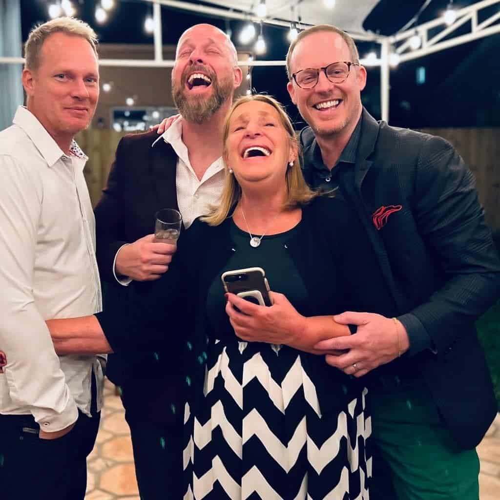The three founding brothers of Tiny Homes Village with their mother