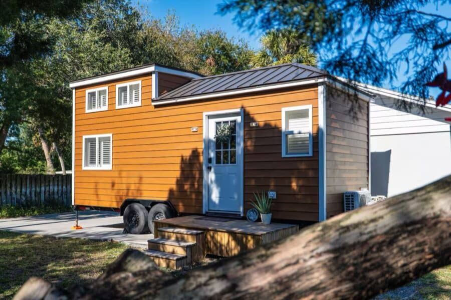 Charming tiny house on wheels featuring vibrant exterior and seaside-inspired surroundings in Melbou.
