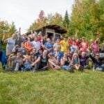 Group of people at Tiny House Summer Camp in Vermont, celebrating small space living.