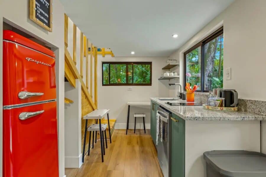 Bright and functional kitchen with modern appliances in the Palm Tree Getaway Tiny House.