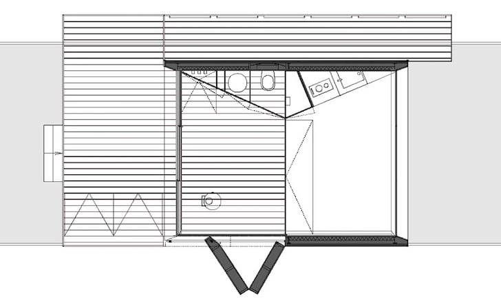 Floor plan drawing showing the bathroom and kitchen double wall, main living space, and outdoor deck layout
