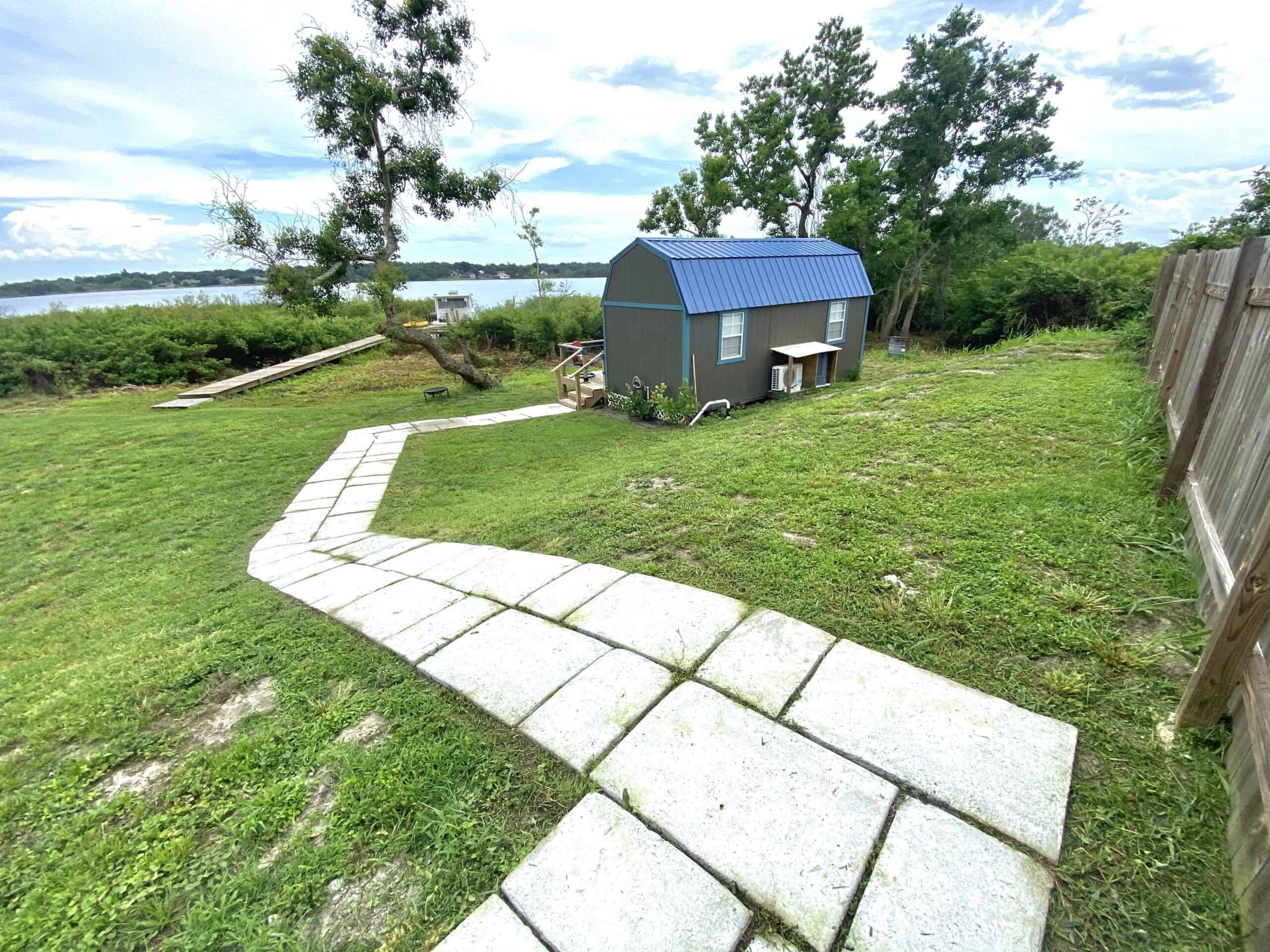 Stone path leading to the tiny lake cottage with lake view in Winter Haven Florida