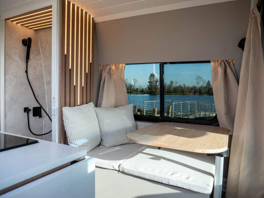 Efficient van conversion with a compact seating area and scenic river view.