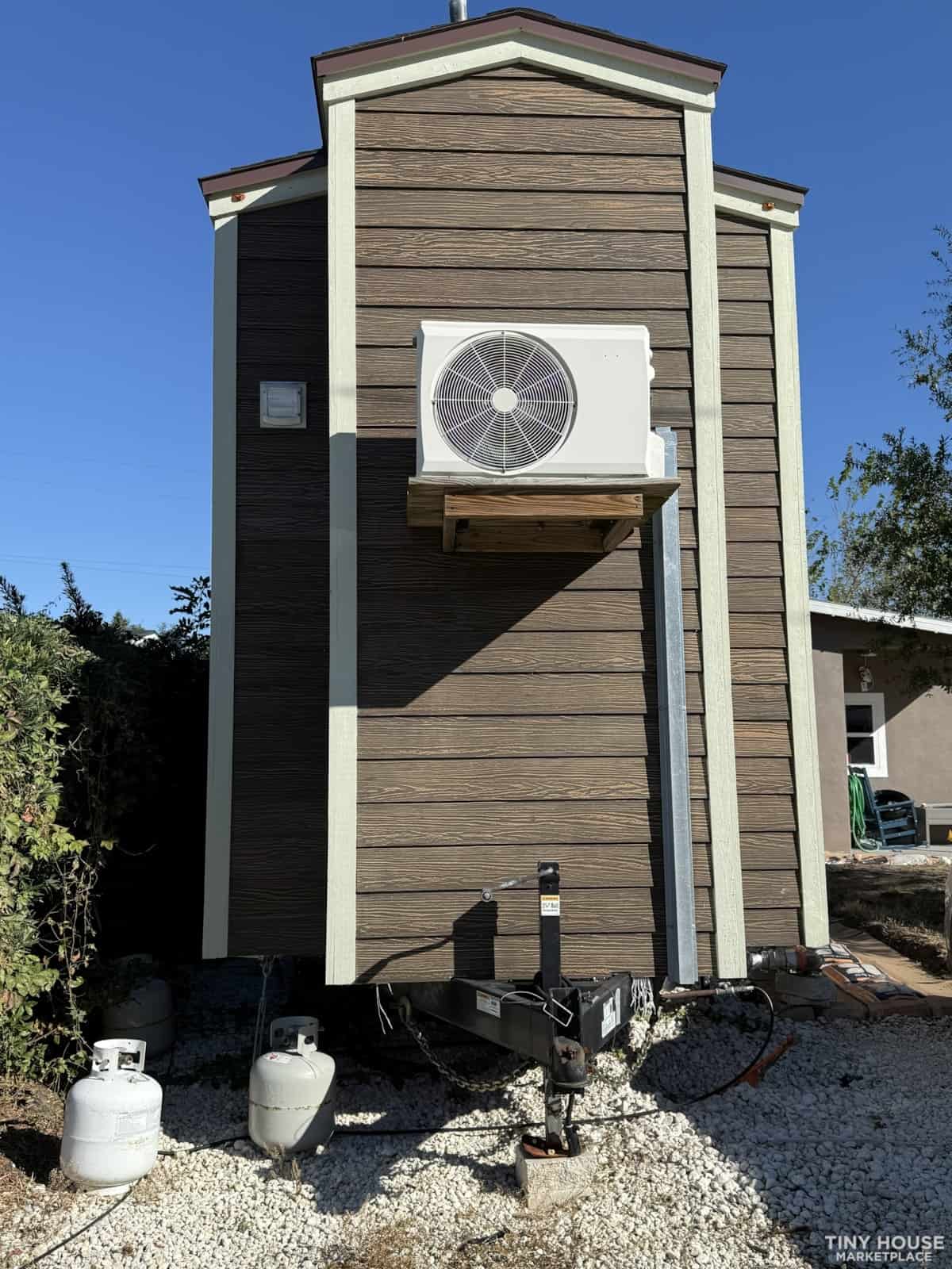 Air-conditioned tiny house exterior with modern design and small footprint.