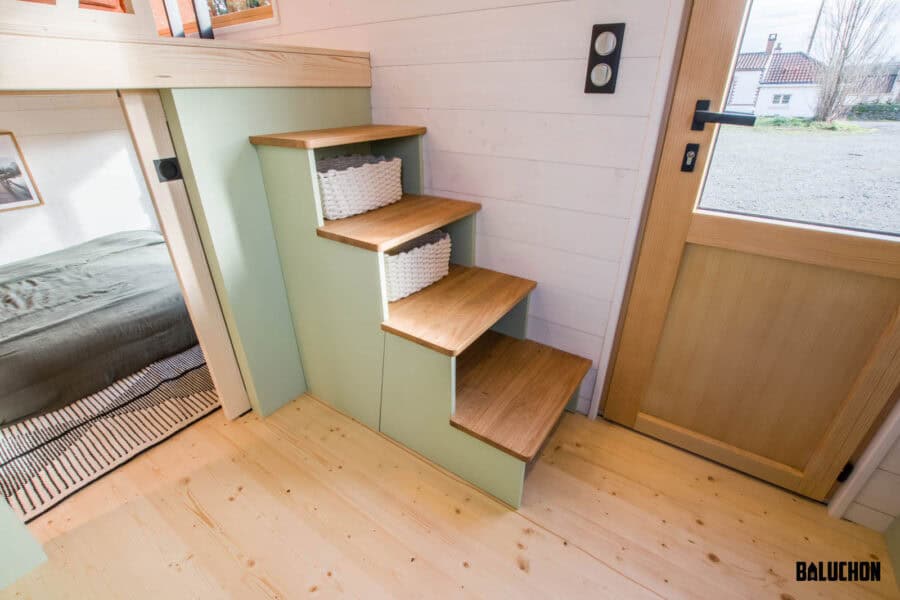 Compact tiny house with creative flex room loft and stairs.