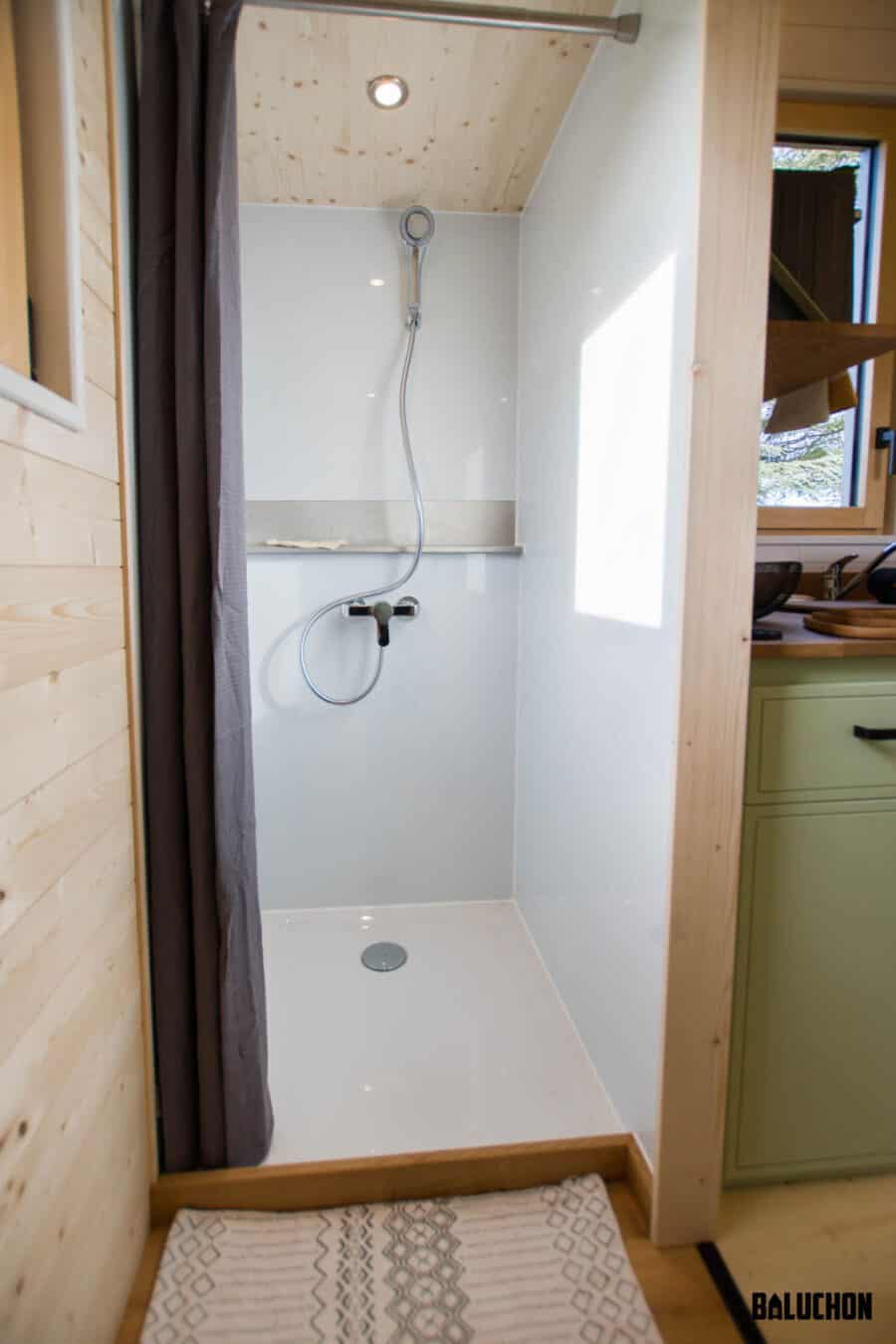 Compact tiny house shower with a creative flex room loft for versatile small space living.