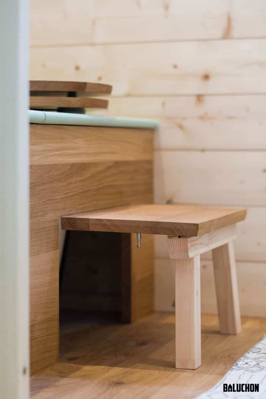 Small wooden flex room loft in a tiny house with natural wood interior.