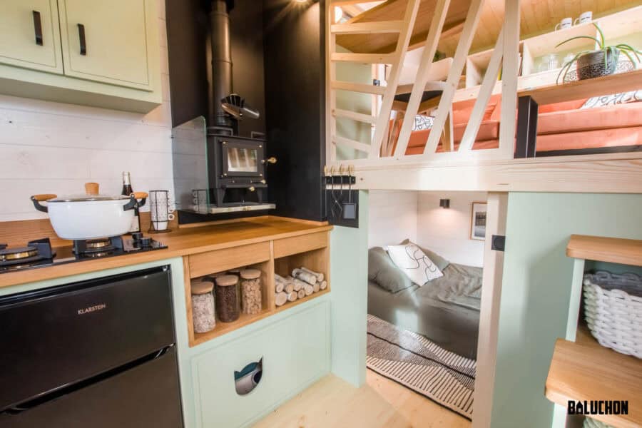 Compact tiny house interior with a flexible loft room and cozy sleeping nook. Perfect for small spac.