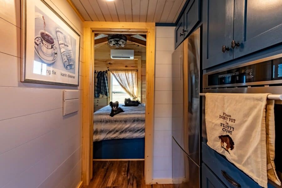 Cozy tiny house interior with wood accents and compact kitchen on 35 acres.
