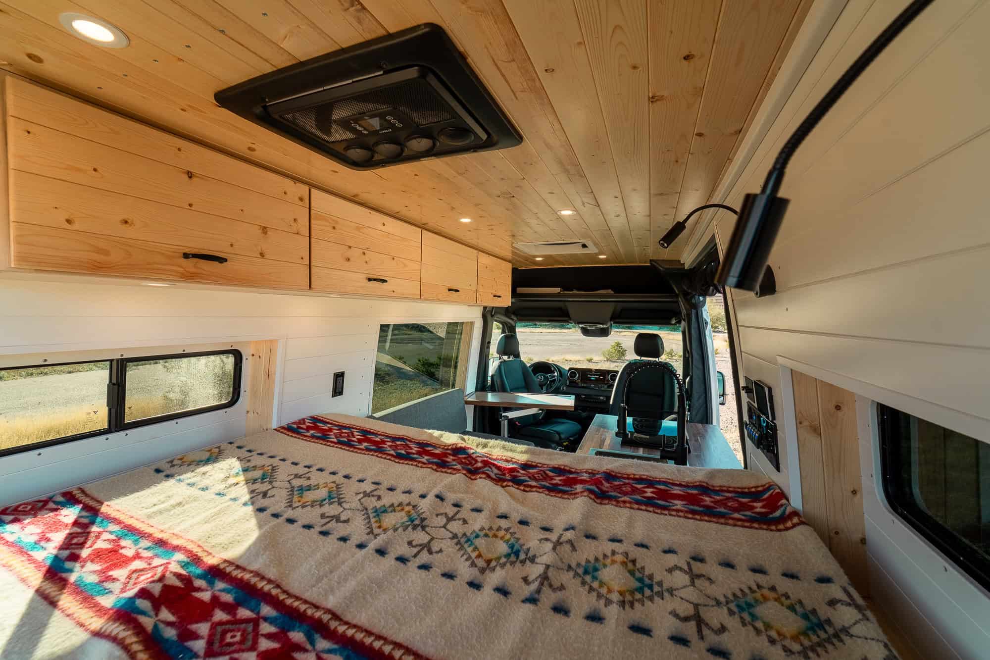 View forward from the rear bed through the galley toward the cab of the Sprinter camper van