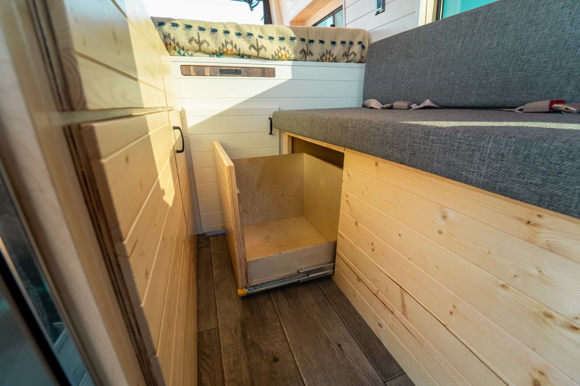 Pull-out storage drawer on full-extension slides built into the base of the bench seat