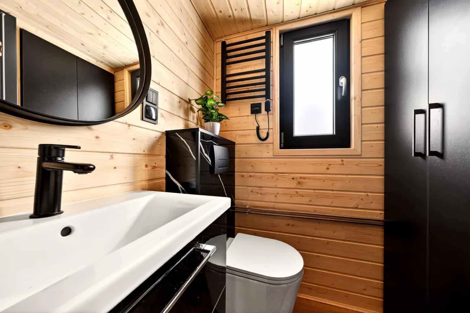 Bathroom sink and tall storage cabinet in the Tommy tiny house