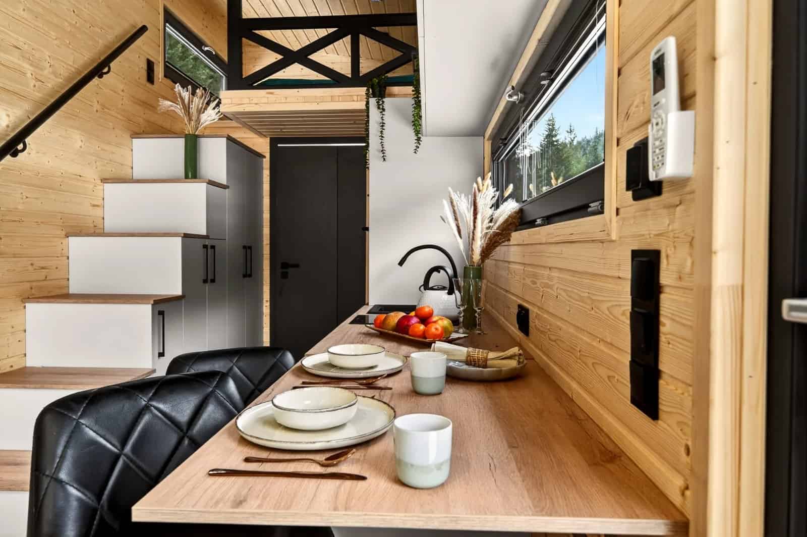 Dining bar set for a meal along the window wall of the Tommy tiny house
