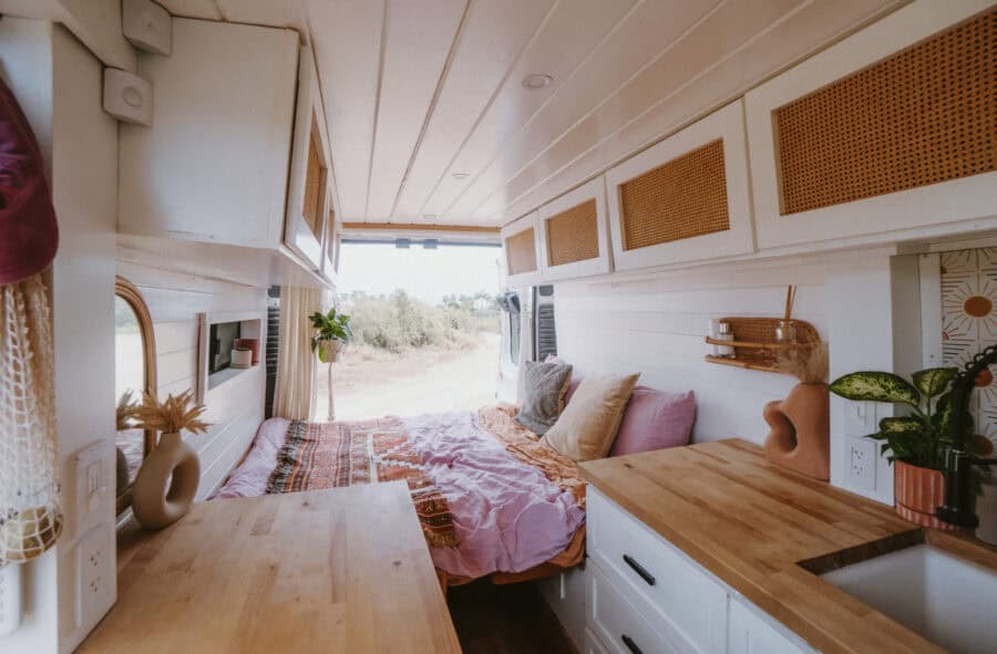Compact tiny house interior with a bed and natural light, perfect for small space living and outdoor.