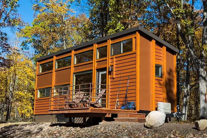 Modern tiny house with lake view and outdoor deck at Canoe Bay.