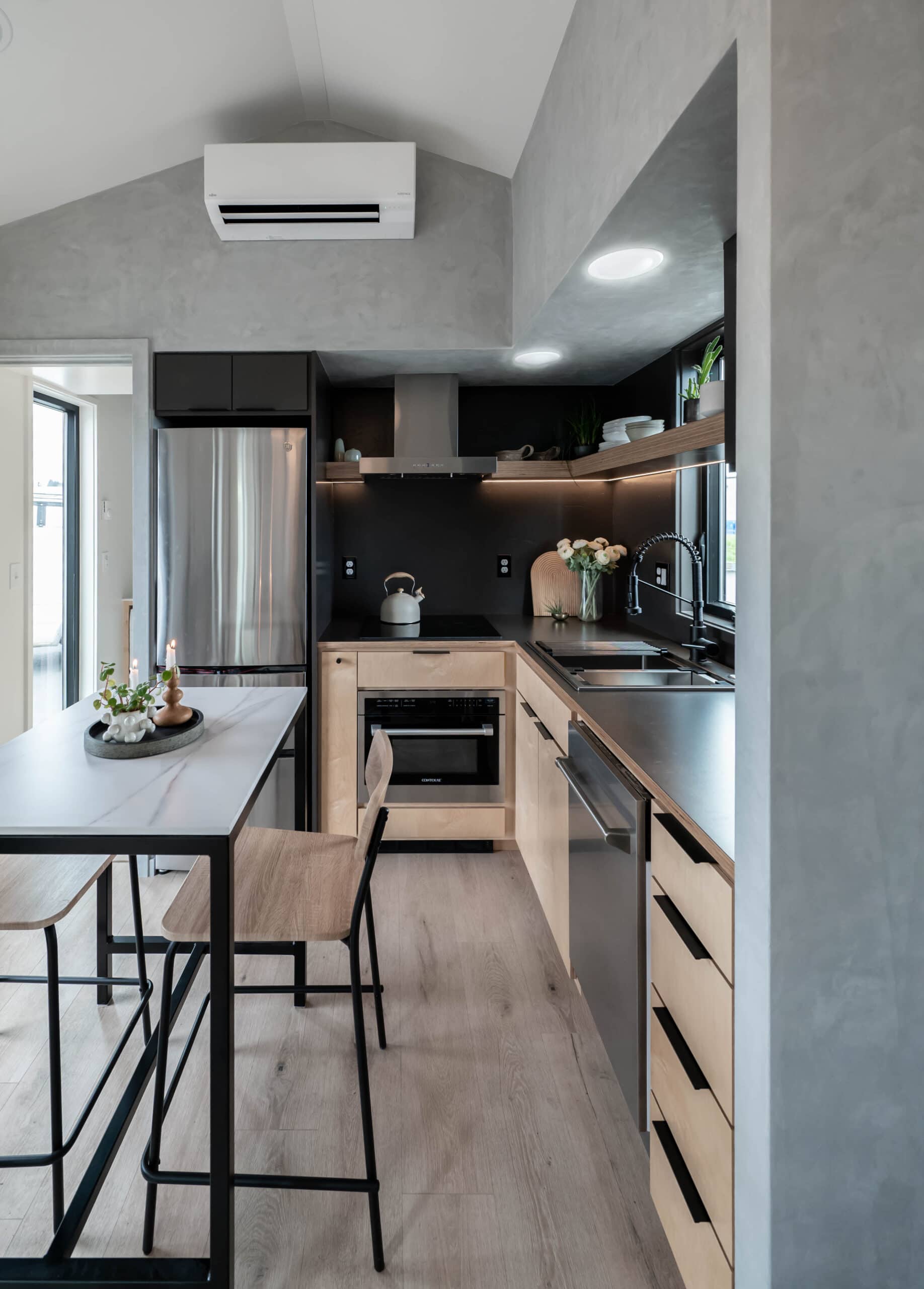 Kitchen detail showing induction cooktop, maple cabinetry, and convection oven in the Urban Gable
