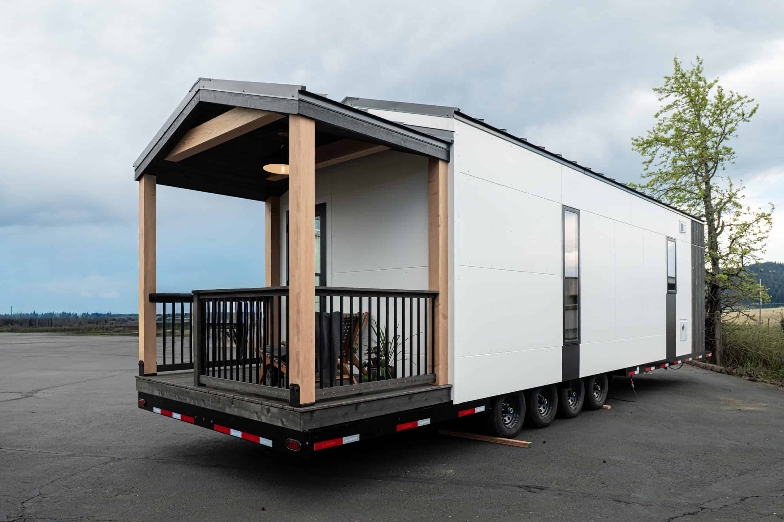 Tru Form Tiny Urban Gable Park model exterior with covered deck, white panels, and gable roof on wheels