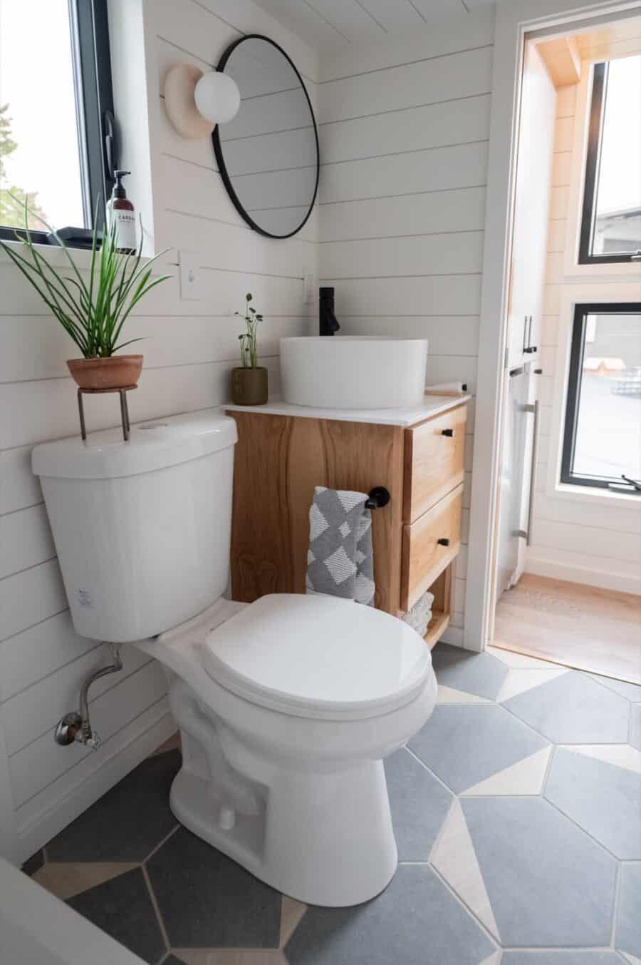 Compact bathroom in a tiny house with modern fixtures and natural light.