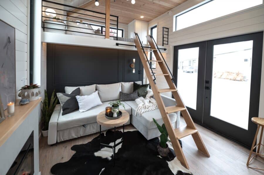Urban park studio tiny house interior with loft and modern decor.