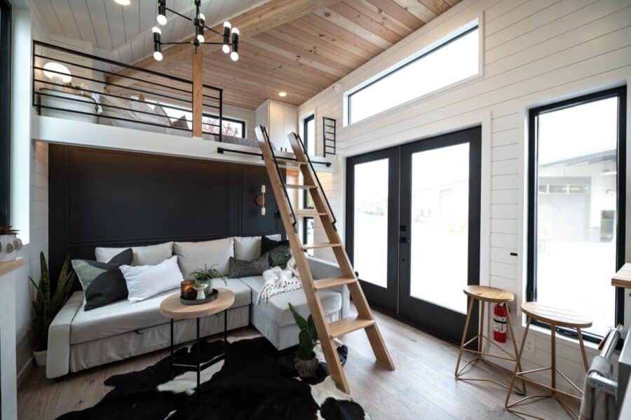 Compact urban tiny house interior with loft and modern design.