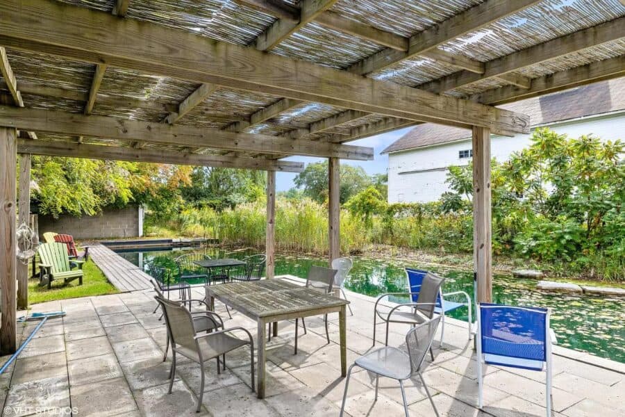 Aluminum patio with seating overlooking pond at Tryon Farms.