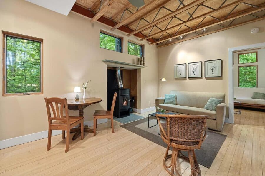 Modern tiny house interior featuring a cozy living area with large windows and natural light.