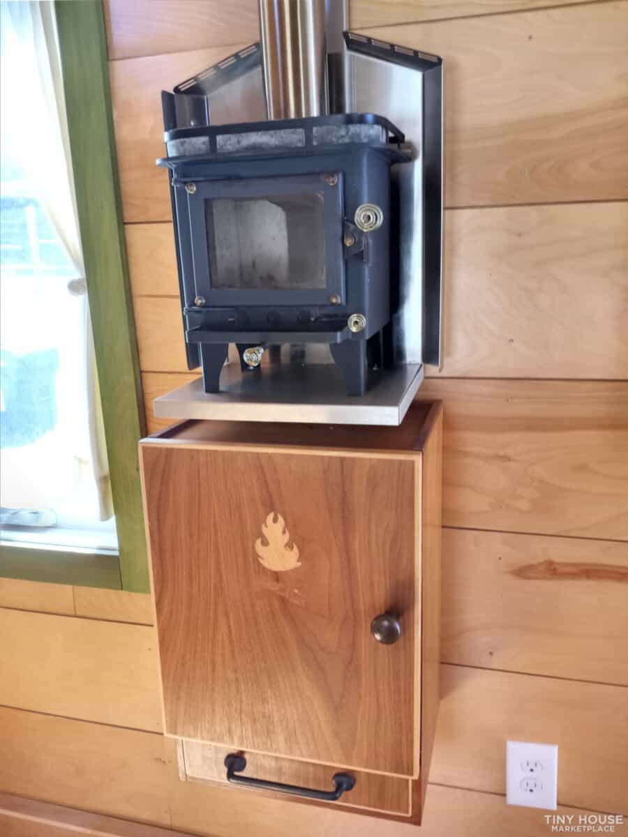 Compact wood stove for tiny house heating and cozy ambiance.