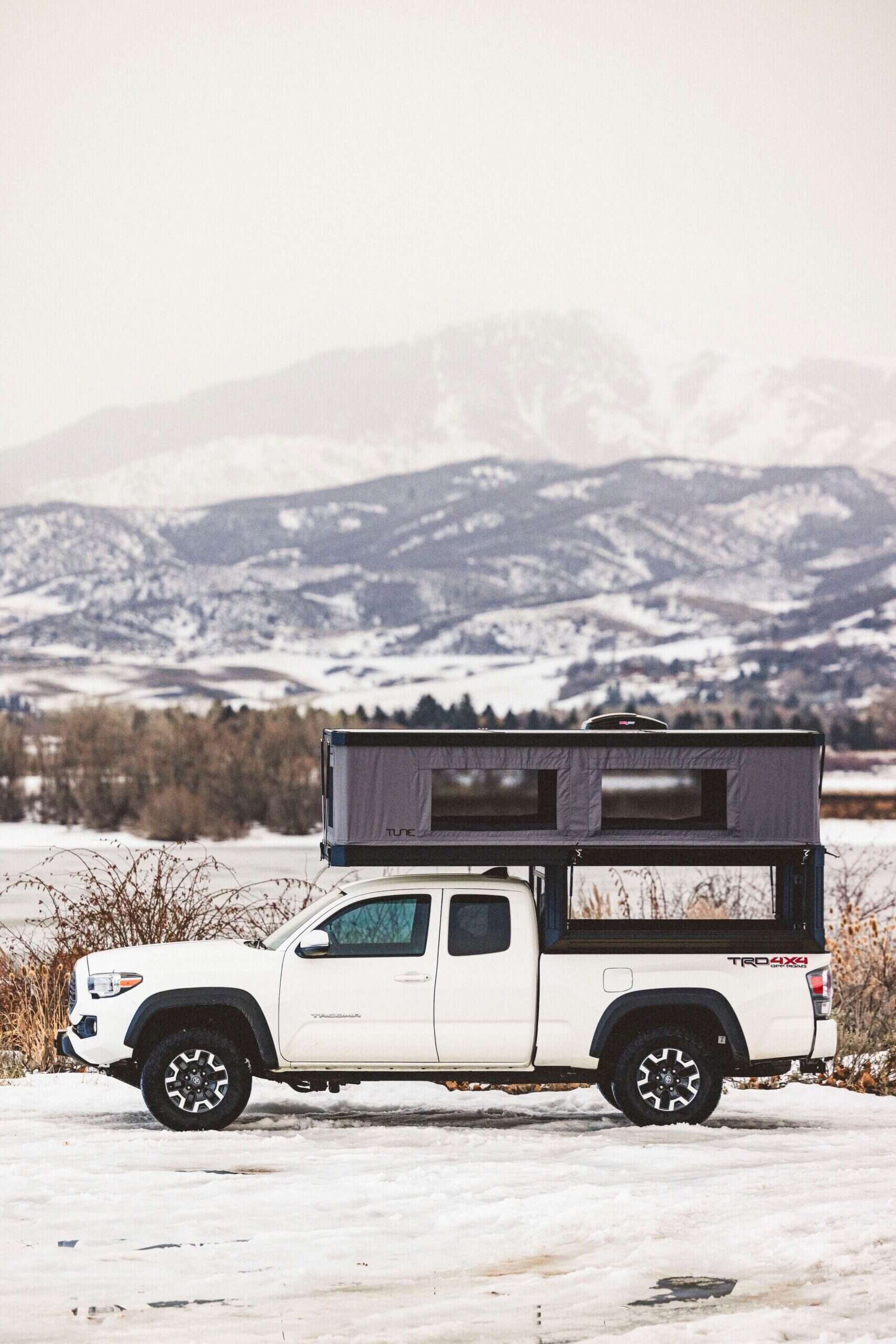 Tune M1 truck bed camper showing the expanded interior space