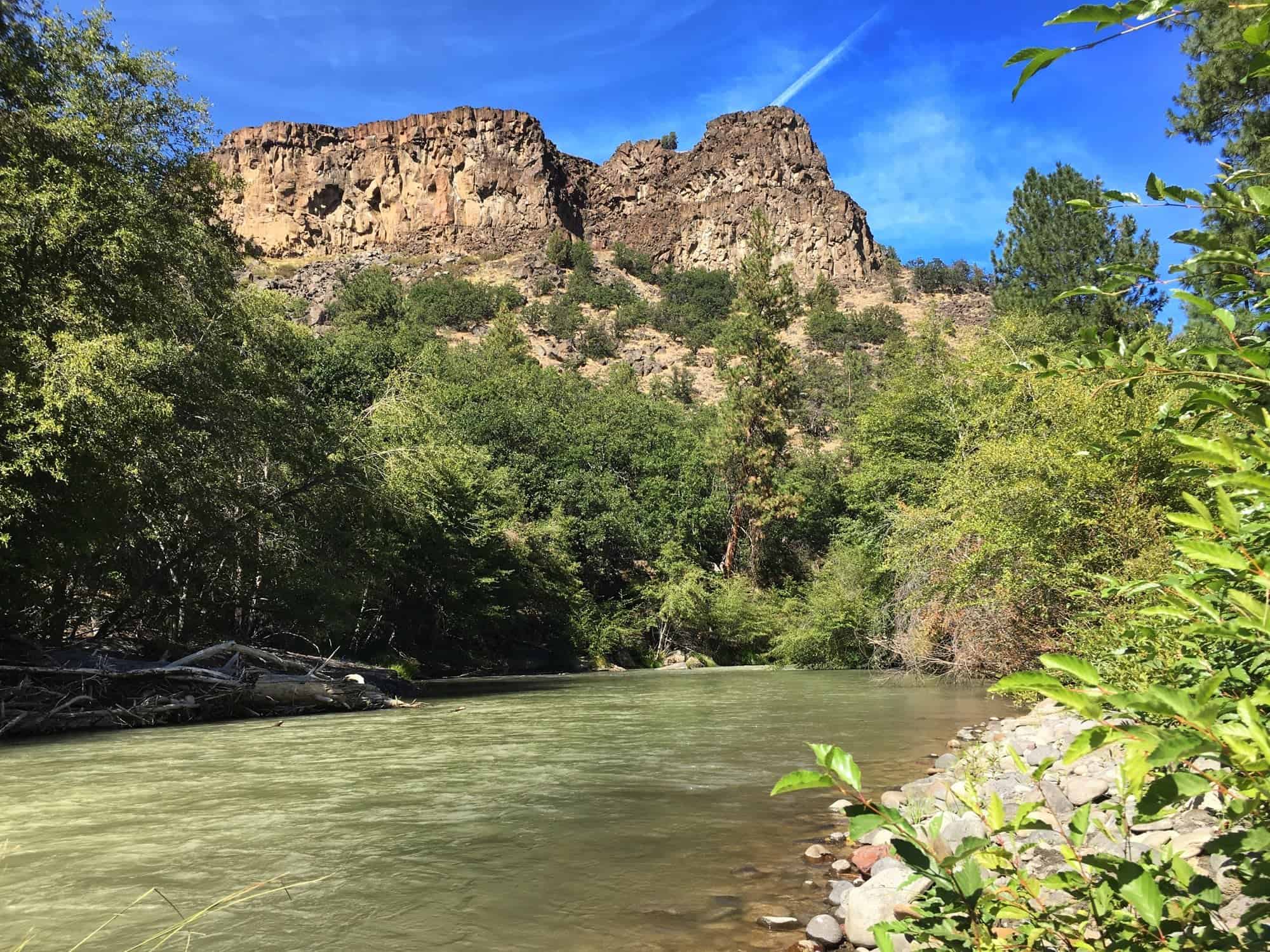 The White River flowing beneath basalt cliffs on the private canyon property near the cabin