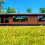 Lakefront tiny house with large windows and modern design in Wisconsin.