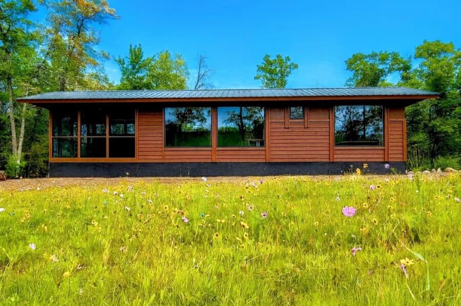 Lakefront tiny house with large windows and modern design in Wisconsin.