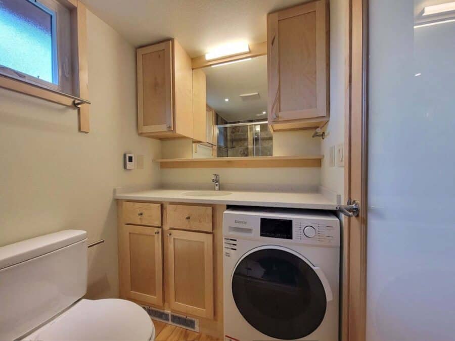 Efficient laundry space inside a classic tiny house at Canoe Bay Village, Wisconsin.