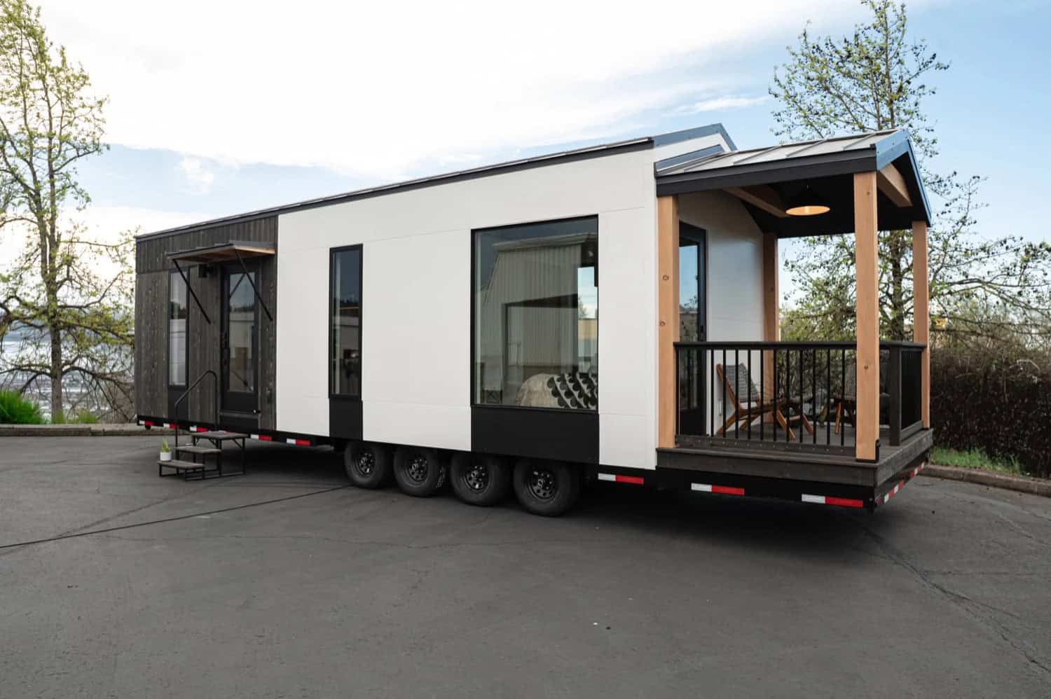 Side view of the Urban Gable Park tiny home showing the covered deck and large windows
