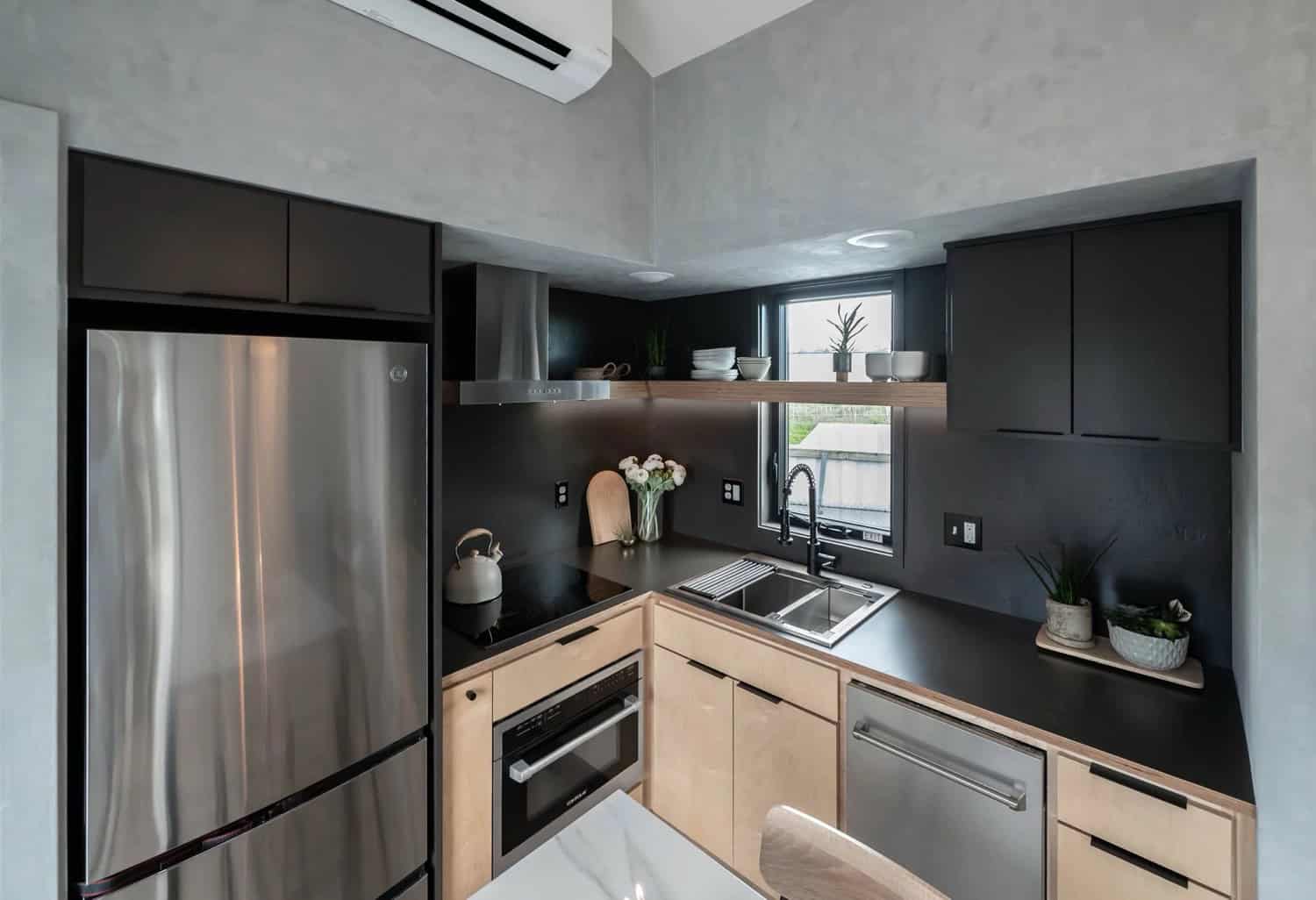 Close-up of the Urban Gable Park kitchen with induction cooktop, maple cabinets and dark counters