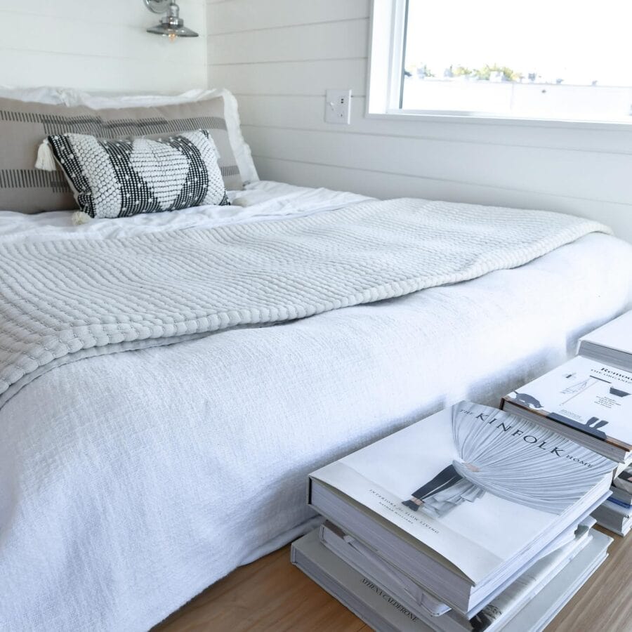 Modern tiny house bedroom with minimalist decor and natural light.