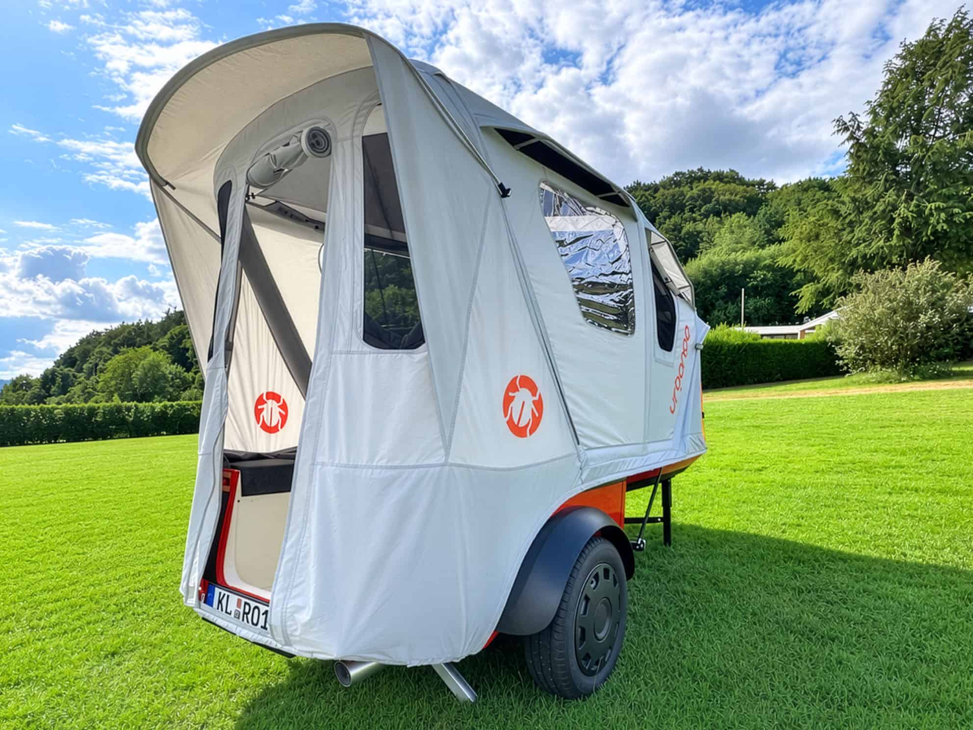 Rear three-quarter view of the Urbanoid Booba with the hatch raised and tent canopy extended