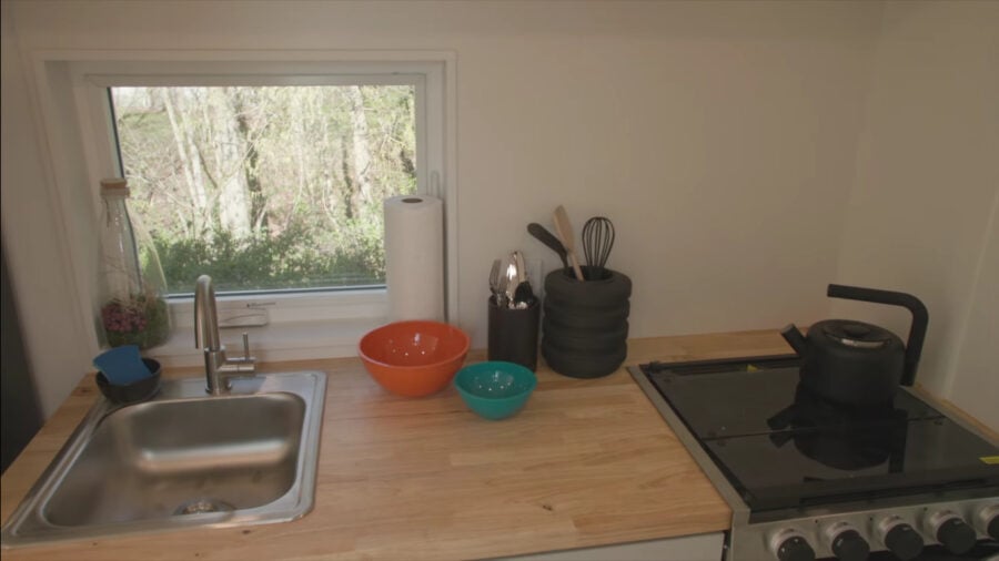 Compact 28-foot VIA tiny house interior with modern kitchen and cozy living space.