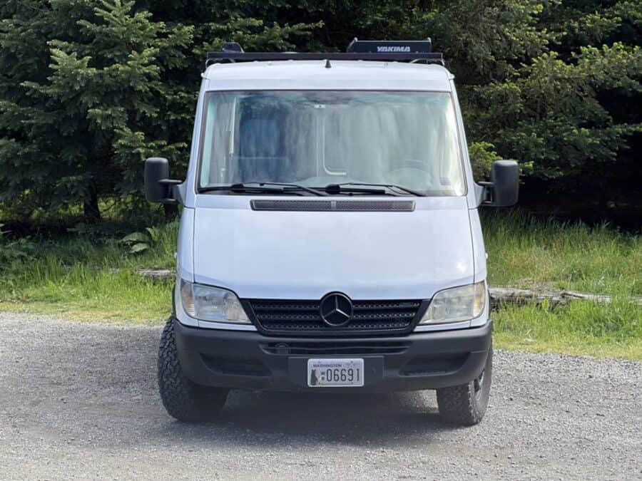 Modern van interior with CNC-milled wood and solar setup.