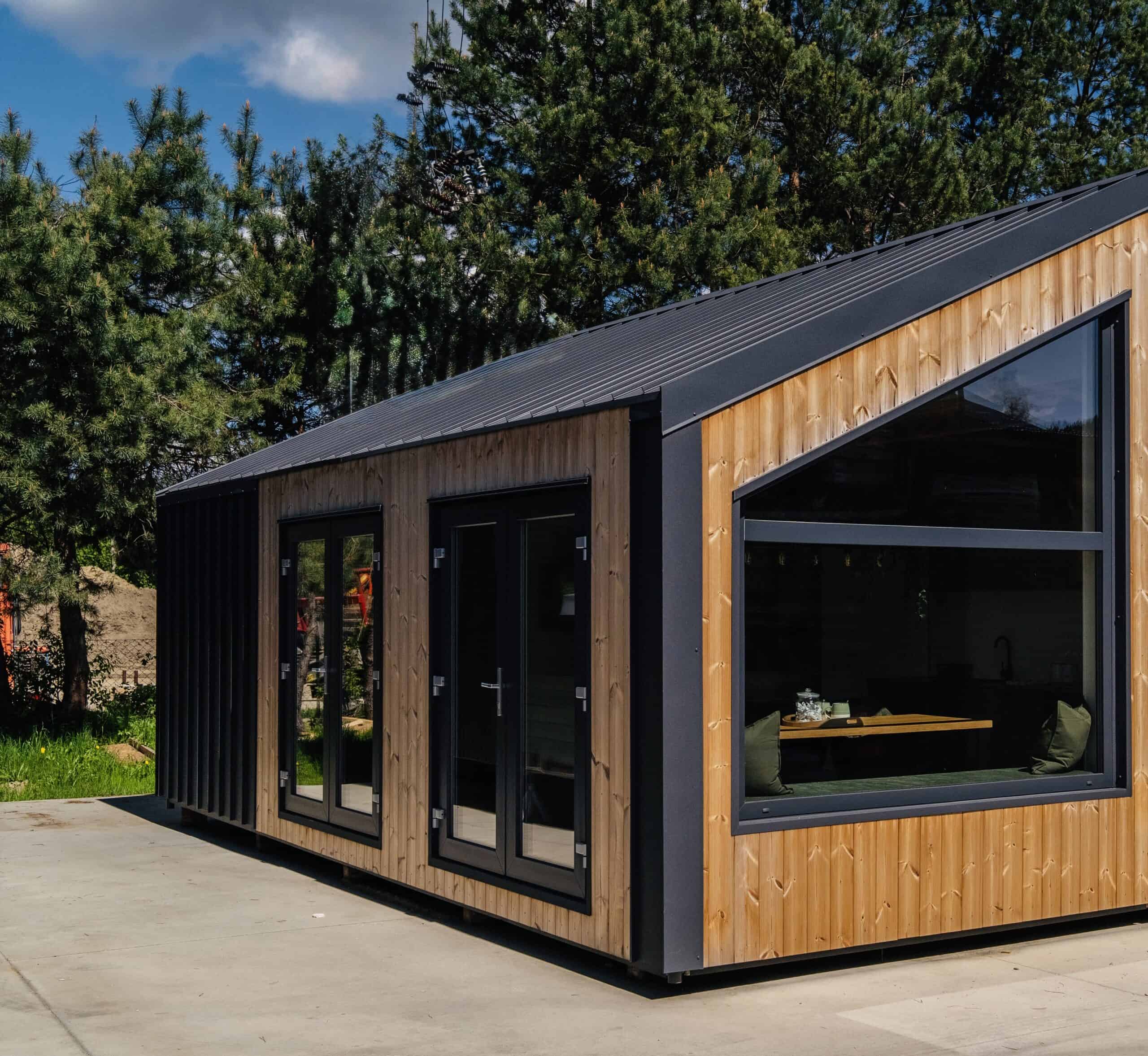 The Vagabond Haven Evergreen modular home clad in ThermoWood and black metal with a steel roof and large angular window