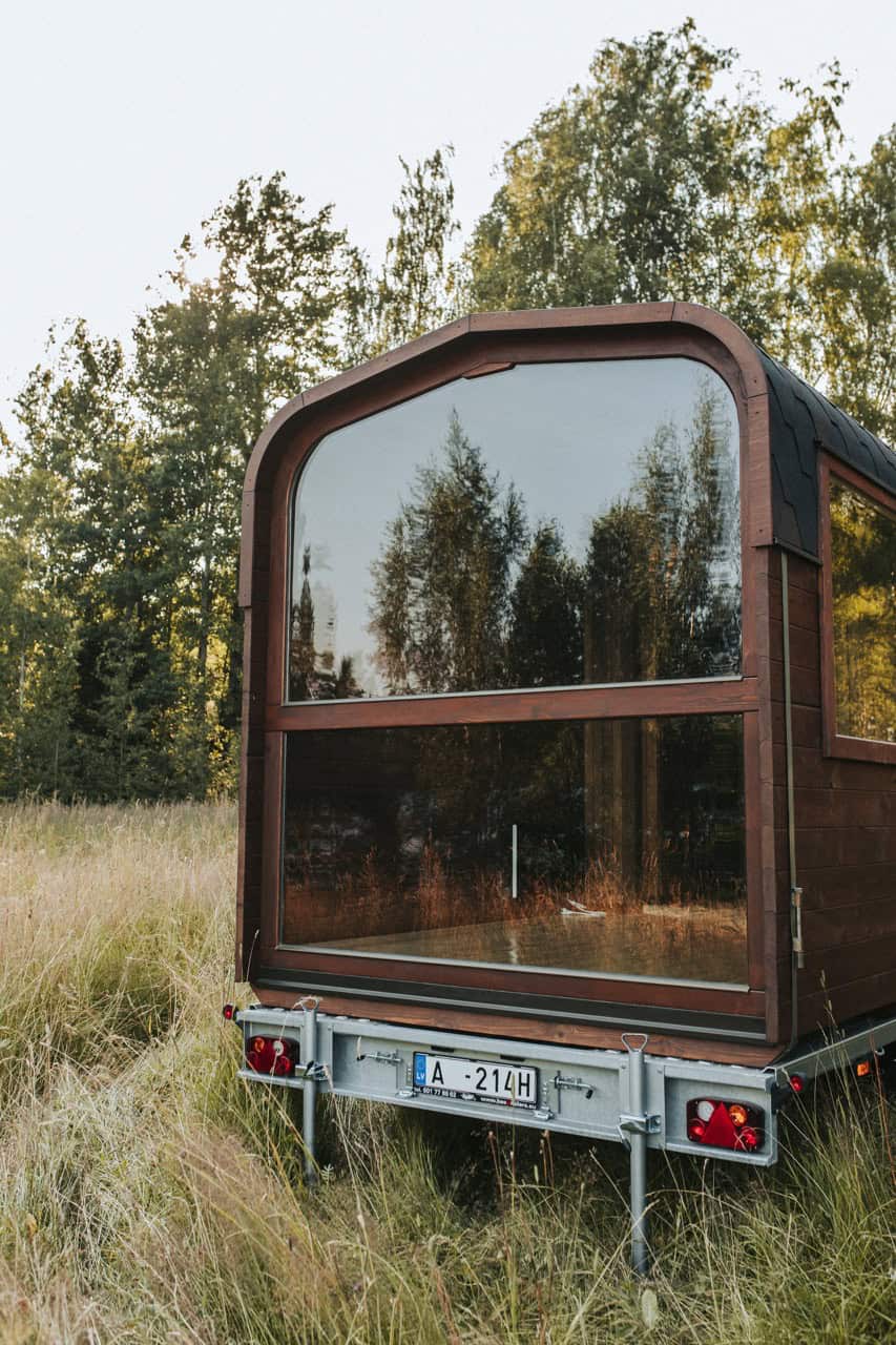 The large rear panorama window of the Nature Pod framing the surrounding trees