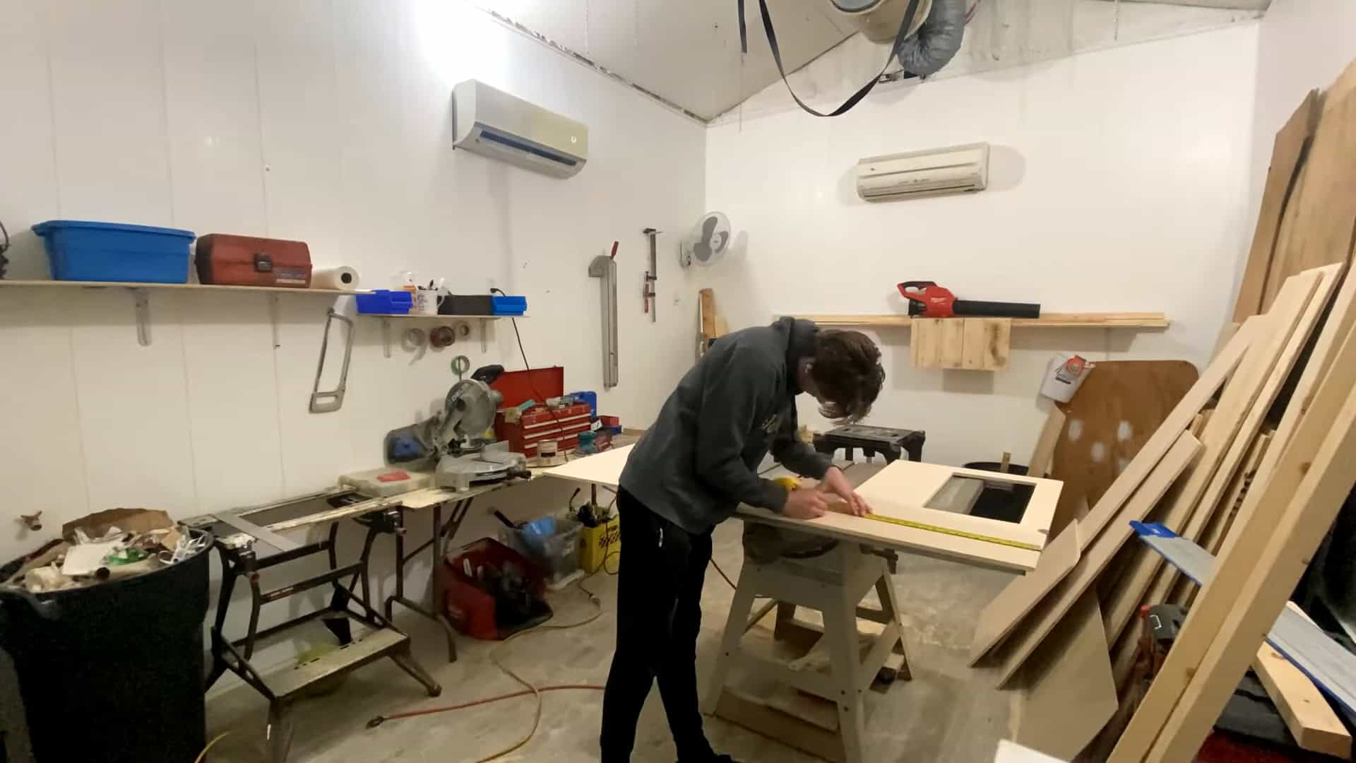 Measuring and cutting the plywood kitchen countertop in the workshop