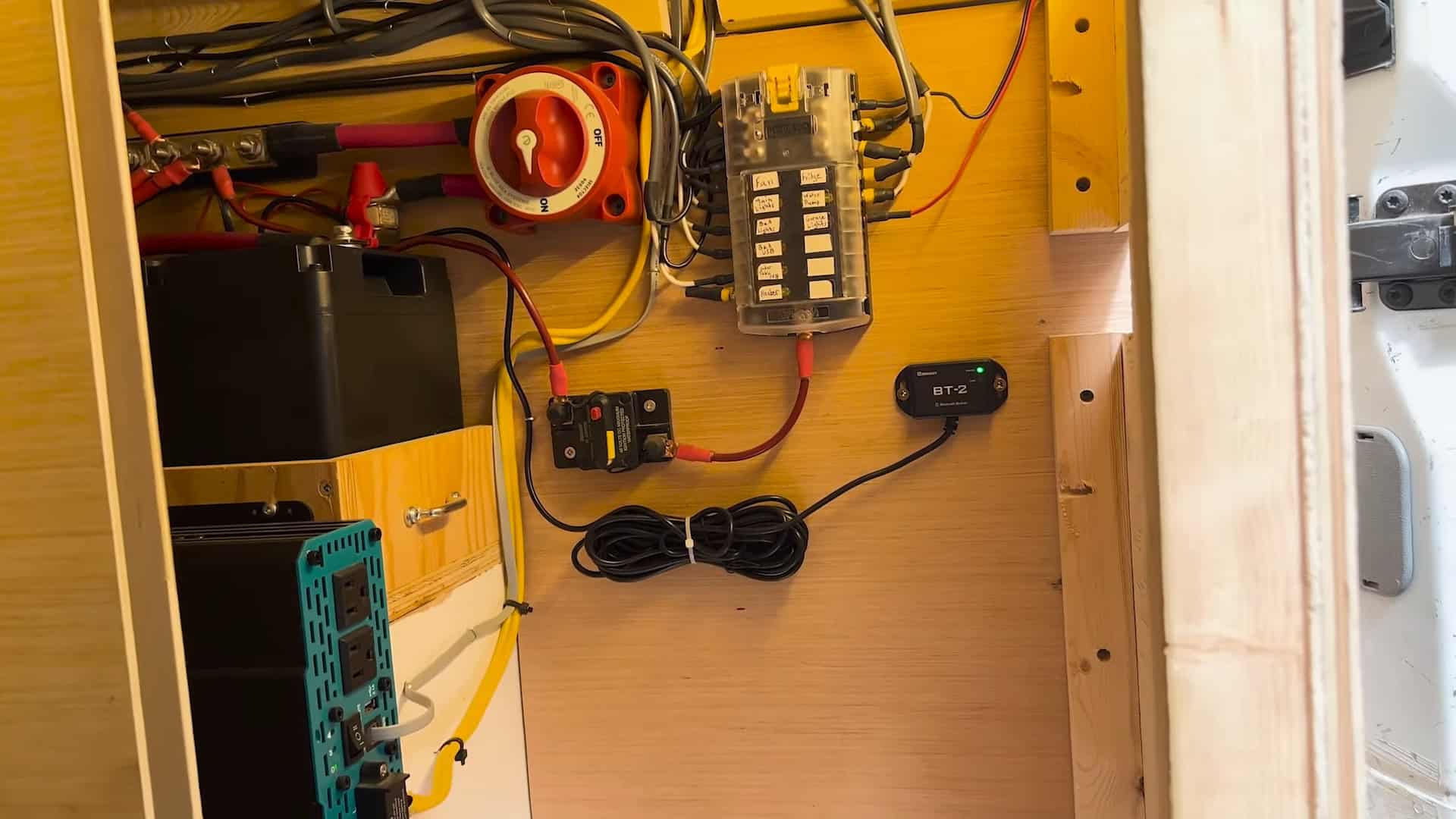 Van electrical system with a Blue Sea battery switch, labeled fuse block, inverter, and Renogy BT-2 monitor