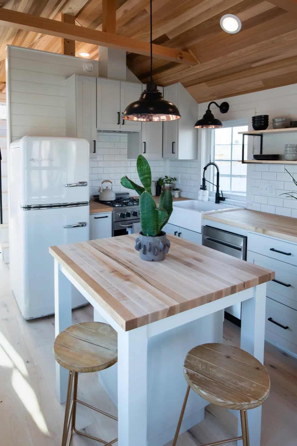 Villa Max kitchen with butcher-block island, retro refrigerator and vaulted wood ceiling