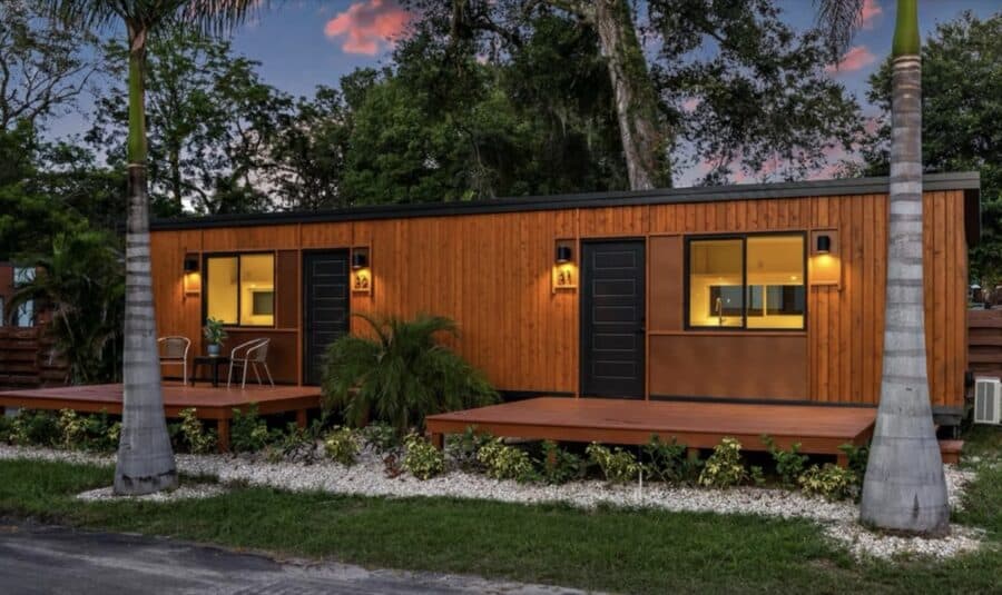 Modern tiny house villa with wooden exterior and outdoor deck in Florida.