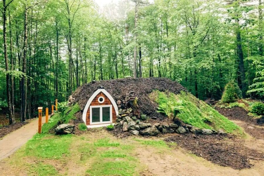 Underground tiny house nestled in lush green forest at Purposely Lost Retreat.